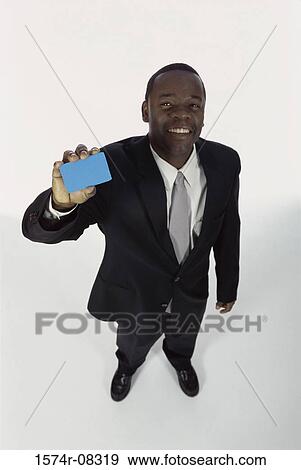Portrait of a businessman holding a blank card View Large Photo Image Stock Photo - Portrait of a businessman holding a blank card. Fotosearch