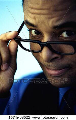 Portrait of a businessman holding his eyeglasses View Large Photo Image Stock Image - Portrait of a businessman holding his eyeglasses. Fotosearch