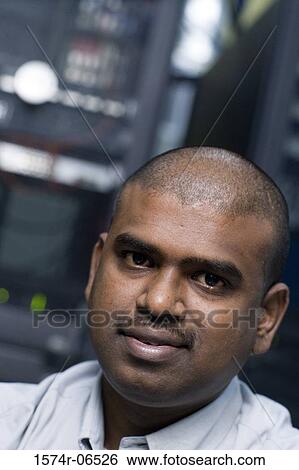Stock Photograph - Portrait of a businessman in an office. Fotosearch