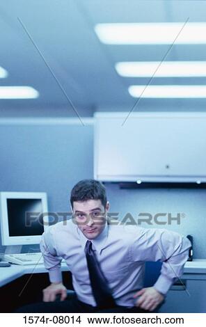 Portrait of a businessman seated at an office desk View Large Photo Image Picture - Portrait of a businessman seated at an office desk. Fotosearch