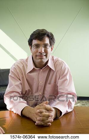 Portrait of a businessman sitting in an office View Large Photo Image Picture - Portrait of a businessman sitting in an office. Fotosearch