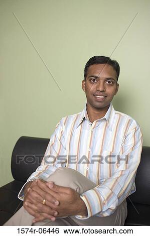 Portrait of a businessman sitting in an office View Large Photo Image Stock Photograph - Portrait of a businessman sitting in an office. Fotosearch