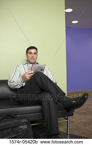Portrait of a businessman sitting on a couch in an office View Large Photo Image Stock Image - Portrait of a businessman sitting on a couch in an office. Fotosearch