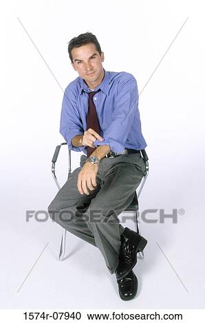 Stock Image - Portrait of a businessman sitting on a chair. Fotosearch