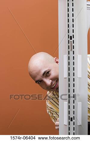 Picture - Portrait of a businessman smiling in an office. Fotosearch