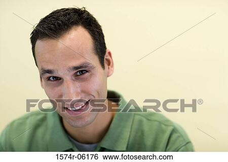 Portrait of a businessman smiling in an office View Large Photo Image Stock Photograph - Portrait of a businessman smiling in an office. Fotosearch