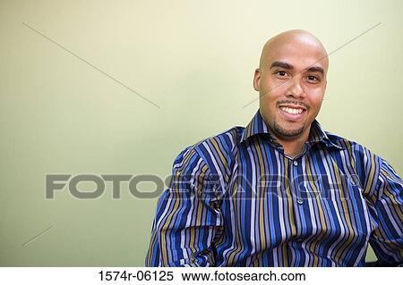 Portrait of a businessman smiling in an office View Large Photo Image Stock Photography - Portrait of a businessman smiling in an office. Fotosearch