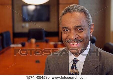 Portrait of a businessman smiling View Large Photo Image Stock Image - Portrait of a businessman smiling. Fotosearch