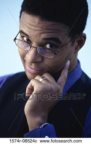 Portrait of a businessman smirking View Large Photo Image Stock Image - Portrait of a businessman smirking. Fotosearch