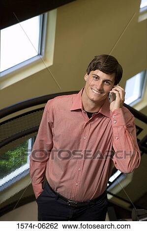 Portrait of a businessman standing on a staircase talking on a mobile phone View Large Photo Image Stock Image - Portrait of a businessman standing on a staircase talking on a mobile phone. Fotosearch