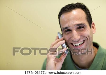 Portrait of a businessman talking on a mobile phone in an office View Large Photo Image Stock Image - Portrait of a businessman talking on a mobile phone in an office. Fotosearch