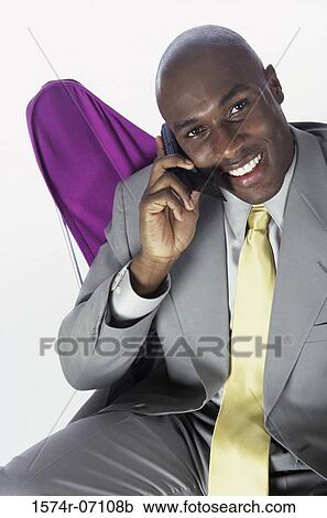Stock Image - Portrait of a businessman talking on a mobile phone. Fotosearch