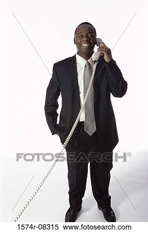 Portrait of a businessman talking on a landline telephone View Large Photo Image Stock Photography - Portrait of a businessman talking on a landline telephone. Fotosearch