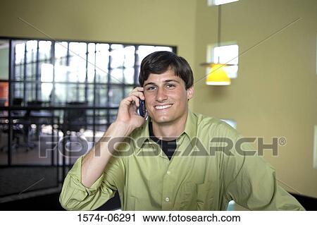 Portrait of a businessman using a mobile phone in an office View Large Photo Image Stock Image - Portrait of a businessman using a mobile phone in an office. Fotosearch