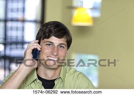 Portrait of a businessman using a mobile phone in an office View Large Photo Image Stock Image - Portrait of a businessman using a mobile phone in an office. Fotosearch