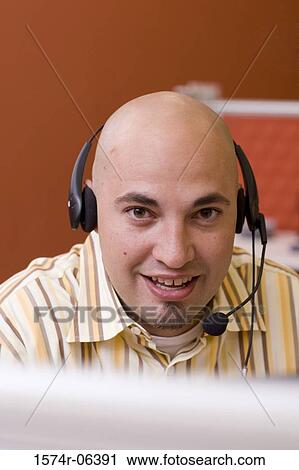 Portrait of a businessman wearing a headset in an office View Large Photo Image Stock Image - Portrait of a businessman wearing a headset in an office. Fotosearch