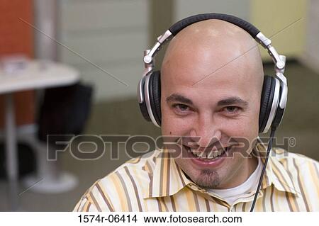Portrait of a businessman wearing headphones in an office View Large Photo Image Picture - Portrait of a businessman wearing headphones in an office. Fotosearch