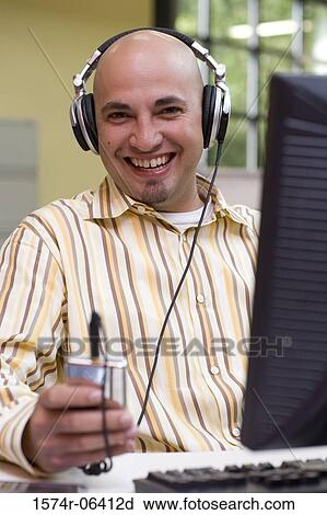 Portrait of a businessman wearing headphones in an office View Large Photo Image Stock Image - Portrait of a businessman wearing headphones in an office. Fotosearch