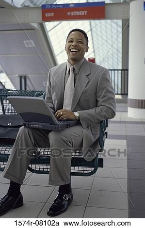 Portrait of a businessman working on a laptop View Large Photo Image Stock Image - Portrait of a businessman working on a laptop. Fotosearch