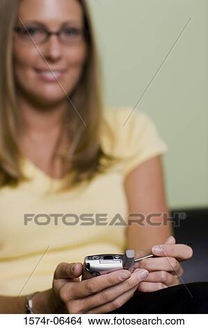 Portrait of a businesswoman holding a hand held device View Large Photo Image Picture - Portrait of a businesswoman holding a hand held device. Fotosearch
