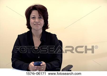 Portrait of a businesswoman holding a hand held device View Large Photo Image Stock Image - Portrait of a businesswoman holding a hand held device. Fotosearch