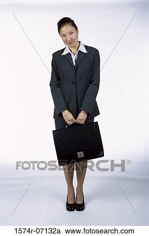 Portrait of a businesswoman holding a briefcase View Large Photo Image Stock Image - Portrait of a businesswoman holding a briefcase. Fotosearch