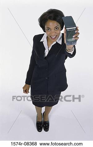 Stock Photo - Portrait of a businesswoman holding a hand held device. Fotosearch