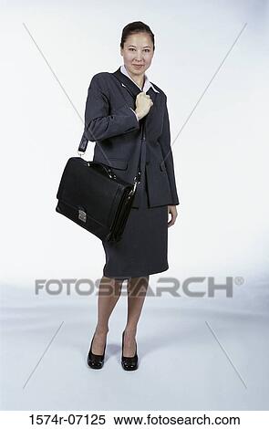 Stock Photography - Portrait of a businesswoman holding a briefcase. Fotosearch