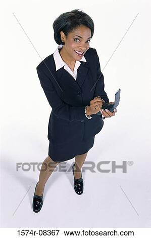 Portrait of a businesswoman operating a hand held device View Large Photo Image Stock Photo - Portrait of a businesswoman operating a hand held device. Fotosearch