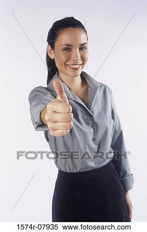 Stock Photography - Portrait of a businesswoman showing thumbs up. Fotosearch