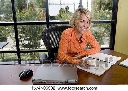 Portrait of a businesswoman sitting in an office View Large Photo Image Stock Image - Portrait of a businesswoman sitting in an office. Fotosearch