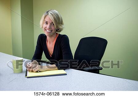 Portrait of a businesswoman sitting in an office View Large Photo Image Stock Photo - Portrait of a businesswoman sitting in an office. Fotosearch