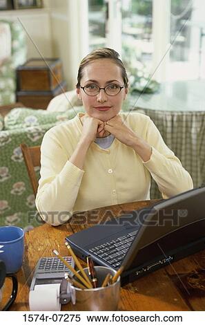 Stock Photography - Portrait of a businesswoman sitting with her hands under her chin. Fotosearch