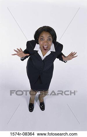 Picture - Portrait of a businesswoman standing with her mouth wide open. Fotosearch