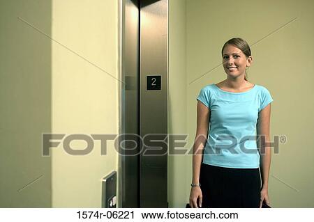 Portrait of a businesswoman standing near an elevator View Large Photo Image Stock Image - Portrait of a businesswoman standing near an elevator. Fotosearch