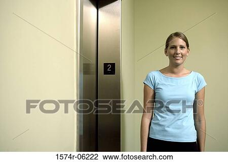 Portrait of a businesswoman standing near an elevator View Large Photo Image Stock Image - Portrait of a businesswoman standing near an elevator. Fotosearch