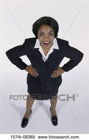 Portrait of a businesswoman standing with her hands on her waist View Large Photo Image Stock Photography - Portrait of a businesswoman standing with her hands on her waist. Fotosearch