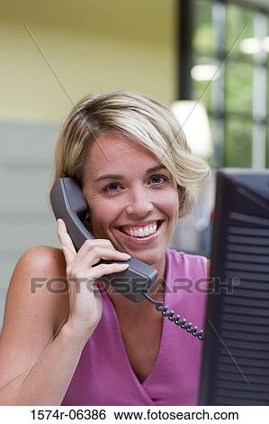 Portrait of a businesswoman talking on a telephone in an office View Large Photo Image Stock Photograph - Portrait of a businesswoman talking on a telephone in an office. Fotosearch