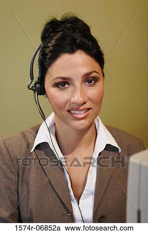 Stock Image - Portrait of a businesswoman wearing a headset. Fotosearch