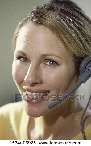 Stock Photography - Portrait of a businesswoman wearing a headset. Fotosearch