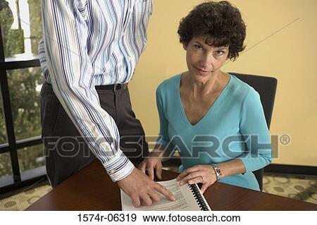 Portrait of a businesswoman with a businessman in an office View Large Photo Image Stock Photo - Portrait of a businesswoman with a businessman in an office. Fotosearch