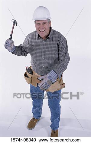 Portrait of a construction worker holding a hammer View Large Photo Image Stock Image - Portrait of a construction worker holding a hammer. Fotosearch