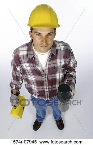 Stock Photography - Portrait of a construction worker holding a lunchbox and a thermos. Fotosearch