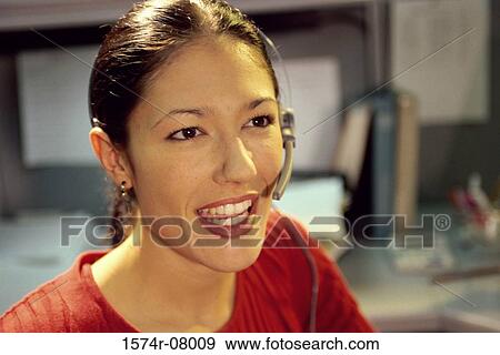 Stock Photo - Portrait of a customer service representative wearing a headset. Fotosearch