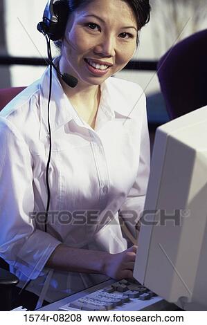 Stock Photo - Portrait of a customer service representative smiling. Fotosearch