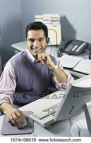 Stock Photo - Portrait of a customer service representative working on a computer. Fotosearch