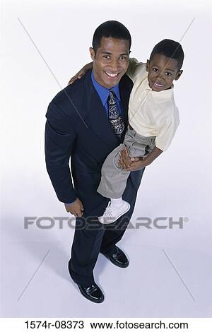 Portrait of a father carrying his son View Large Photo Image Stock Image - Portrait of a father carrying his son. Fotosearch