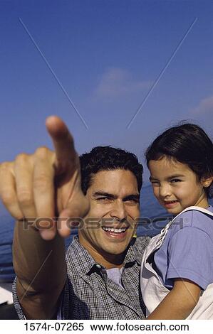 Stock Photography - Portrait of a father carrying his daughter. Fotosearch