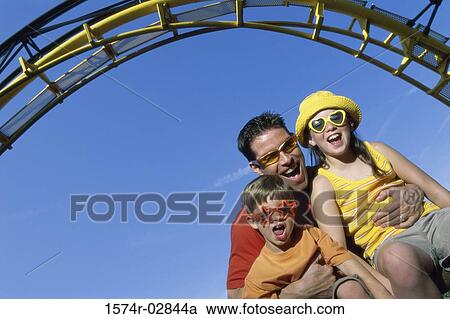 Portrait of a father with his son and daughter on an amusement park ride View Large Photo Image Stock Image - Portrait of a father with his son and daughter on an amusement park ride. Fotosearch