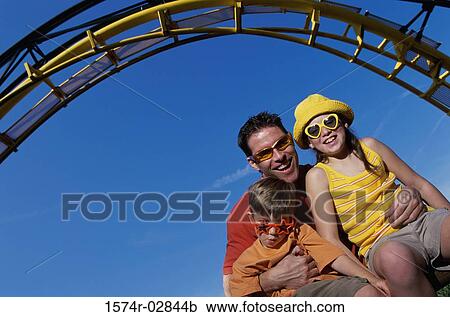 Portrait of a father with his son and daughter on an amusement park ride View Large Photo Image Stock Image - Portrait of a father with his son and daughter on an amusement park ride. Fotosearch